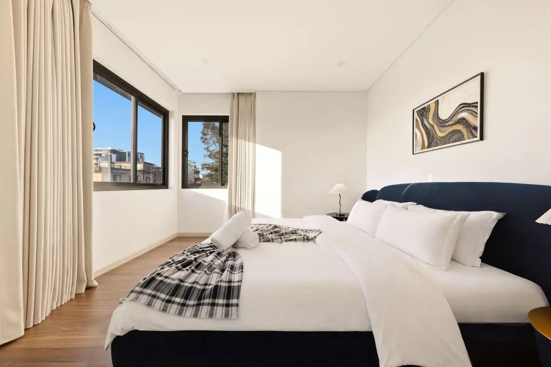 Short-stay bedroom prepared with styled linen for Airbnb photography